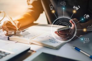 businessman-analyzing-company-financial-report-with-augmented-reality-graphics-scaled